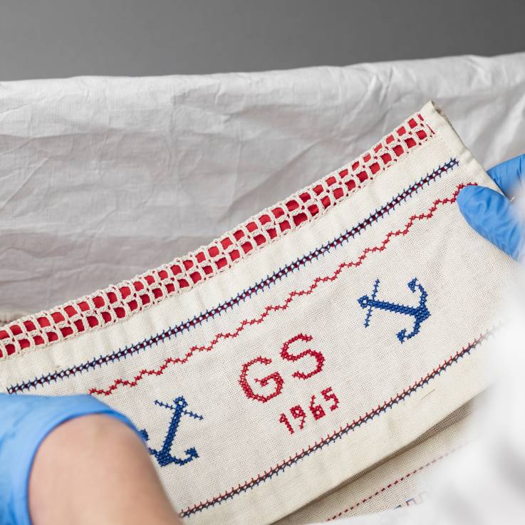 Ein rechteckiges Mustertuch mit den Initialien G.S. und das Jahr 1965